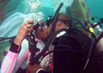Arthur Miller and Kim Terrell-Miller said “I do” in the Caribbean Sea — literally. Byron E Small; Courtesy of Kim Terrell-Miller and Arthur Miller