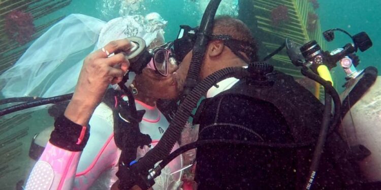 Arthur Miller and Kim Terrell-Miller said “I do” in the Caribbean Sea — literally. Byron E Small; Courtesy of Kim Terrell-Miller and Arthur Miller