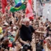 Sao Bernardo do Campo, SP, Brazil - November 9, 2019: Brazil's former President Luiz Inacio Lula da Silva waves a Brazilian flag as he is carried by supporters during a political rally.