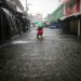 A woman walks along a flooded street during the passage of tropical storm Sara in La Ceiba, Honduras, on November 15, 2024. Honduras' President Xiomara Castro said emergency services had been activated to deal with 'damage already caused by the rains,' warning that Sara's impacts 'could become a catastrophic event.' (Photo by AFP)