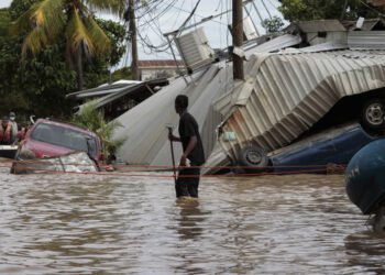A resident examines storm damage caused by Hurricane Eta in Planeta, Honduras, on Nov. 6, 2020.