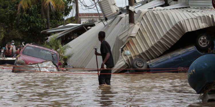 A resident examines storm damage caused by Hurricane Eta in Planeta, Honduras, on Nov. 6, 2020.