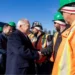 Ontario premier Doug Ford shaking the hand of a worker in an orange hazard and hardhat at a Canadian training facility site for crane operators.