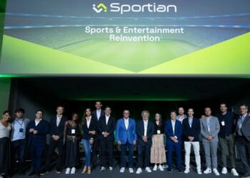 A group of people stands on stage under a large presentation screen displaying the ‘Sportian’ logo and the phrase ‘Sports & Entertainment Reinvention’