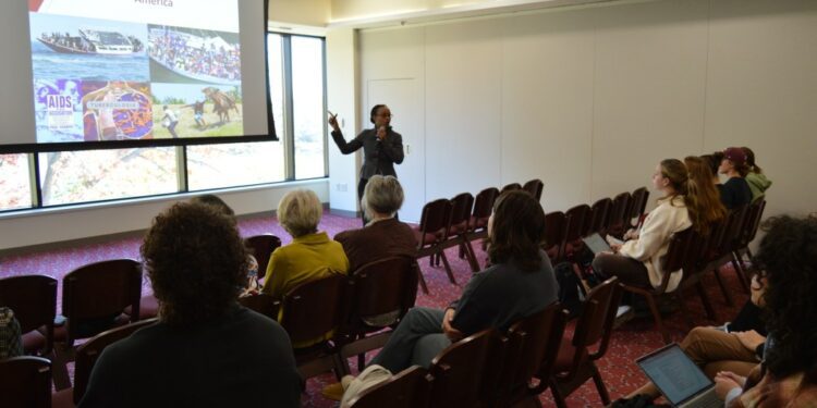 Springfield College Vice President for Campus Life and Inclusion Slandie Dieujuste presents the hate Haitians receive in America