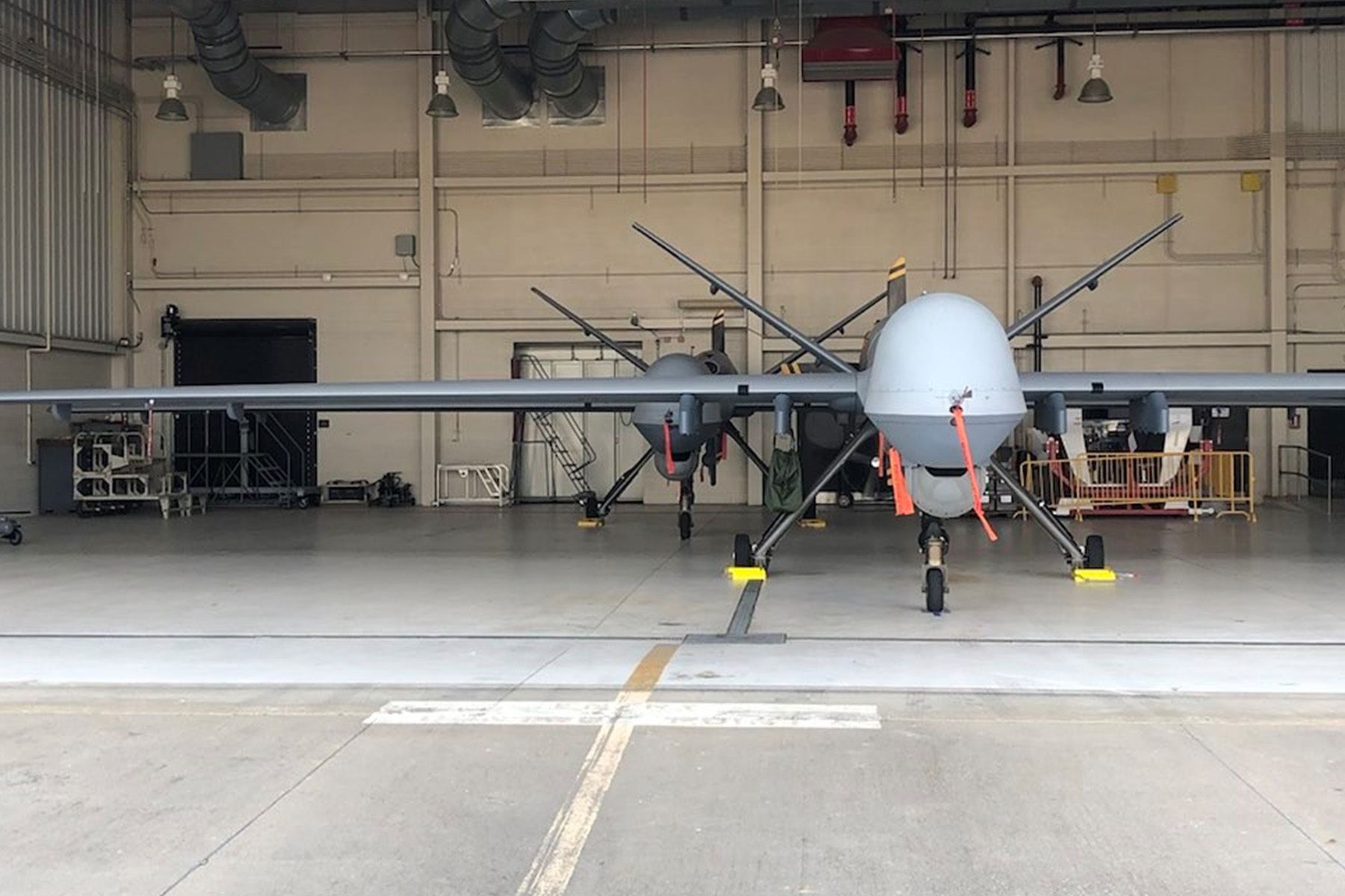 Two Reaper Drones of the Texas ANG's 147th Attack Wing parked in a hangar.