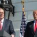 Kevin Hassett speaks at a podium while Donald Trump stands next to him