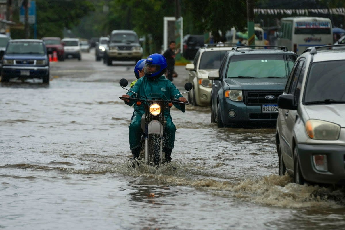 Streets flooded by rains from Tropical Storm Sara in La Lima, Honduras. The storm moved through the Caribbean and doused Honduras with rain on Friday ((AP Photo/Moises Castillo))