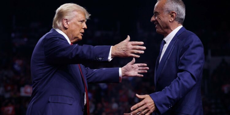 Donald Trump greeting Robert F. Kennedy Jr. on stage during a campaign event at Desert Diamond Arena in Glendale, Arizona, on August 23, 2024.
