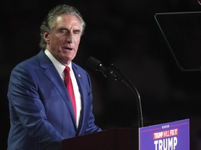 North Dakota Gov. Doug Burgum speaks before Republican presidential nominee former President Donald Trump arrives at a campaign rally at Van Andel Arena, Monday, Nov. 4, 2024, in Grand Rapids, Mich.