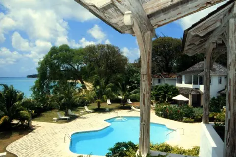 Getty Images A view of a villa with a pool and the sea in the background