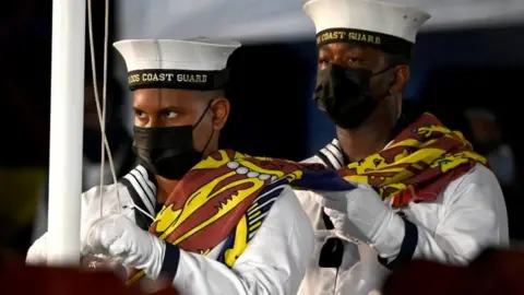 Reuters Members of the Barbados Coast Guard remove The Queen