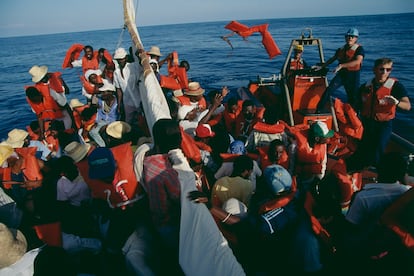 The U.S. Coast Guard arrives at a Haitian refugee boat to distribute life jackets, 1992.