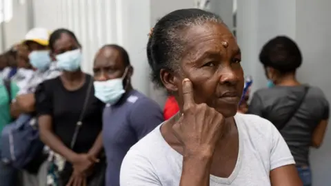 EPA People wait for information about their missing relatives outside the Juan Pablo Pina Hospital, the day after an explosion occurred in San Cristobal, Dominican Republic - 15 August 2023.