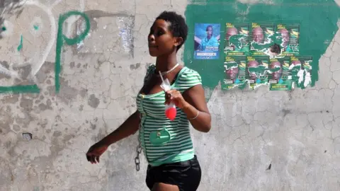 AFP Resident leaves a polling station on 29 December, 2011