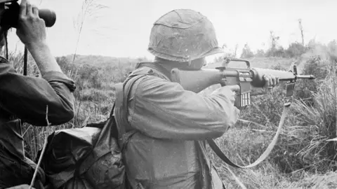 Getty Images US Marine firing M-16 in Vietnam