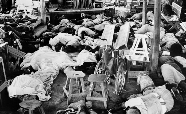 A black and white photo of bodies in a room