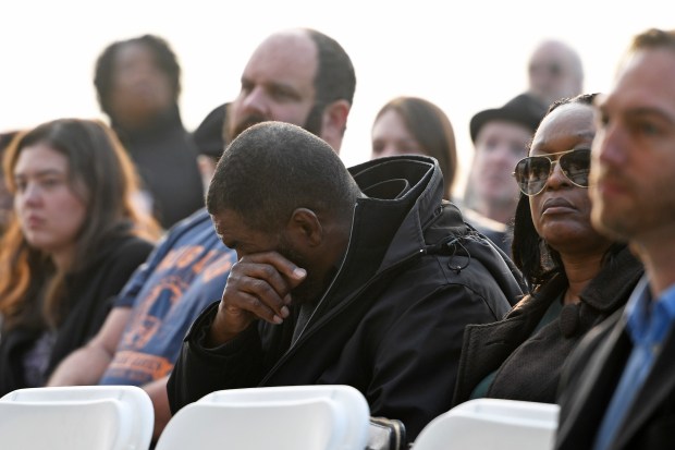 A man wipes away tears while listening to Jonestown survivor...