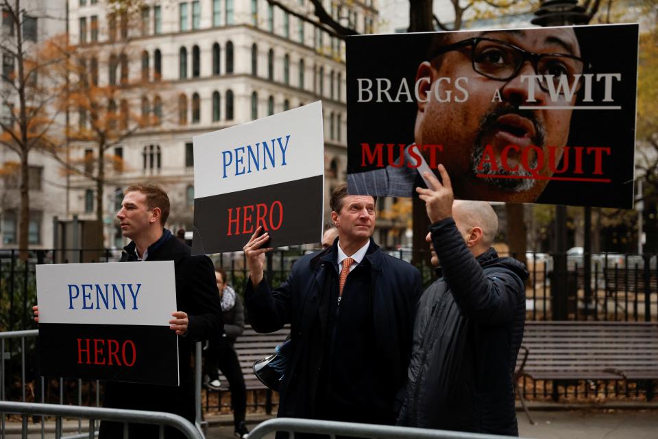 Supporters of Daniel Penny hold signs outside Manhattan Criminal Court.