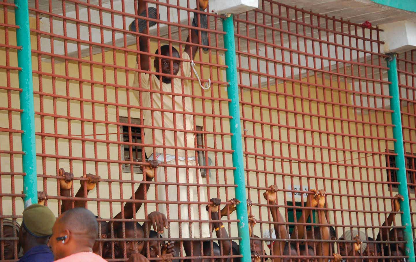 Men imprisoned at the Mafanta Prison peer out at the world. In 2016, Sierra Leone’s Human Rights Commission decried the squalor and lack of rehabilitative programs as “inhumane.”