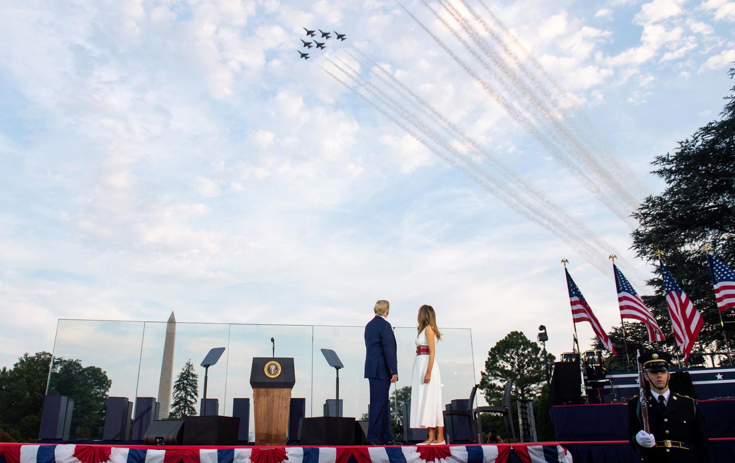 President Donald Trump and first lady Melania Trump watch during a military flyover as they host the 2020 “Salute to America” event in honor of Independence Day on the White House South Lawn.