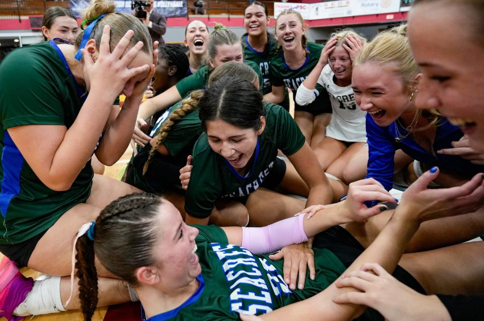 Seacrest Country Day Stingrays players celebrate after defeating the Boca Raton Christian Blazers in the Class 1A state championship game in Winter Haven, Fla.