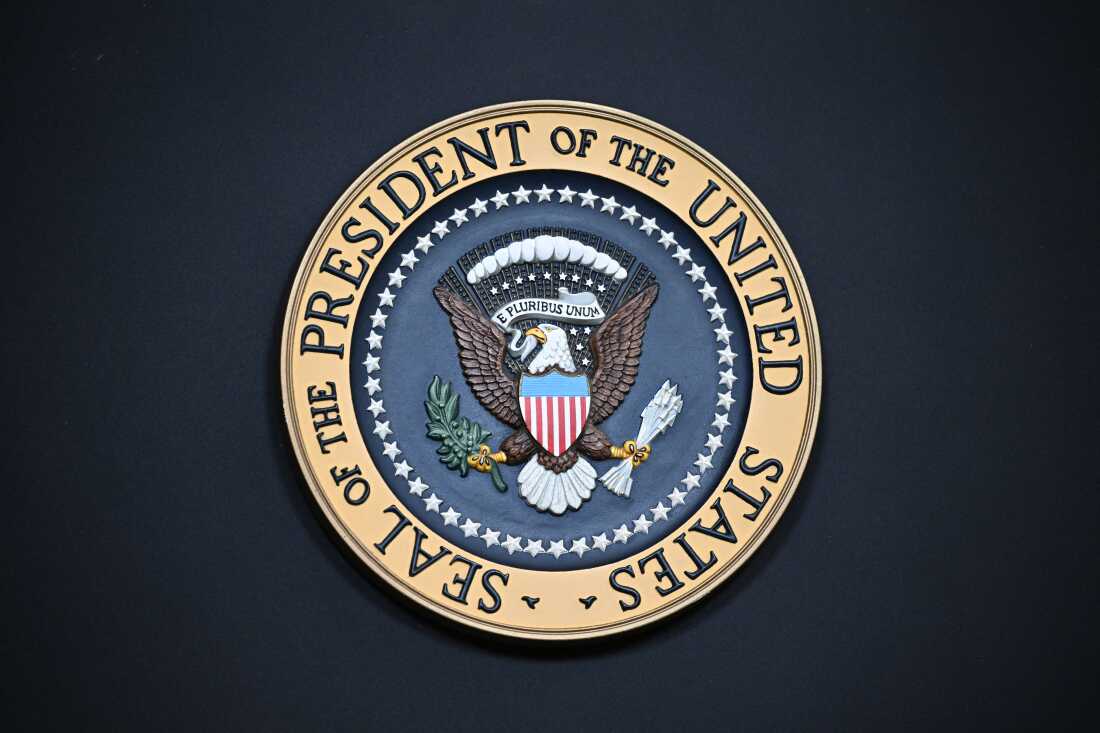 The presidential seal pictured, with a bald eagle front and center. 