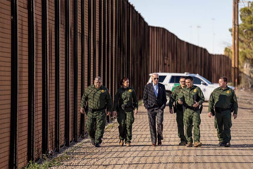 U.S. President Joe Biden walking with Border Patrol officers along the U.S. border wall, illustrating the fall in border crossings, one of the biggest Mexican news stories of 2024