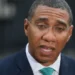 DANIEL LEAL-OLIVAS/GETTY Jamaica's Prime Minister Andrew Holness speaks to the media outside 10 Downing Street in central London, on 17 April 2018