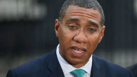 DANIEL LEAL-OLIVAS/GETTY Jamaica's Prime Minister Andrew Holness speaks to the media outside 10 Downing Street in central London, on 17 April 2018