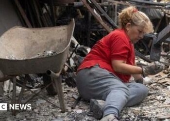 Burned cars stand outside the devastated home of Patricia Araya, known as 'La Pati,' a staff at the Botanical Garden of Vina del Mar who died in a fire along with her mother and her two grandchildren, aged 9 and one, in Vina del Mar, Chile, 05 February 2024