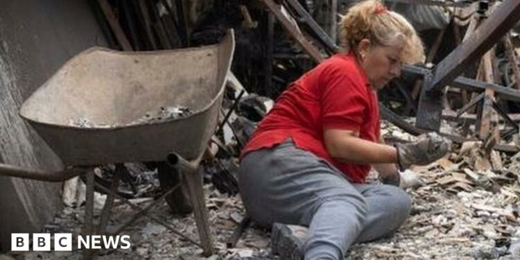 Burned cars stand outside the devastated home of Patricia Araya, known as 'La Pati,' a staff at the Botanical Garden of Vina del Mar who died in a fire along with her mother and her two grandchildren, aged 9 and one, in Vina del Mar, Chile, 05 February 2024