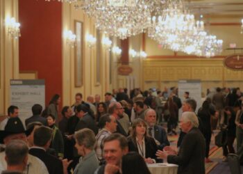 People mingle in the hallway of the Colorado River Water Users Association conference at the Paris Hotel in Las Vegas on December 5, 2024. The event brought together more than 1,500 water experts from across the Southwest.