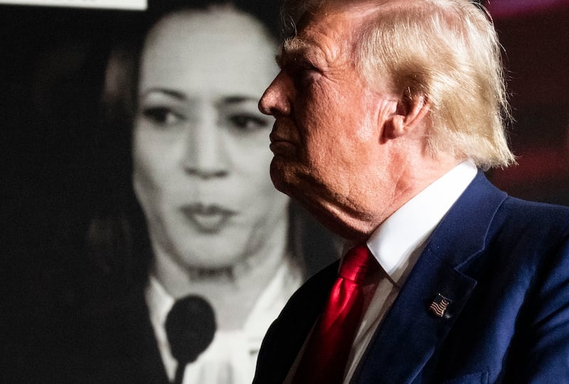 A campaign video for Kamala Harris appears behind Donald Trump during one of his rallies, in Las Vegas, in September. Photograph: Doug Mills/The New York Times
                      