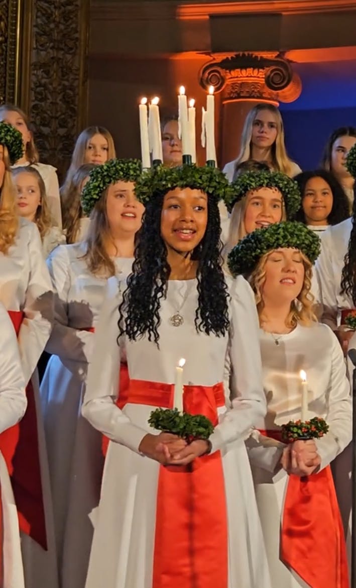 Still from the St. Lucia choir in Helsinki, with Finland's first Black St. Lucia singing in the center of the group.