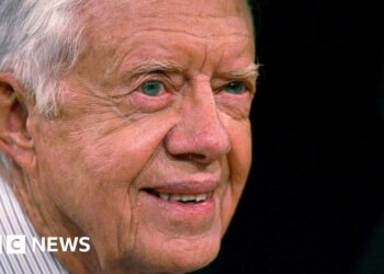 Jimmy Carter smiles into the distance in his old age.