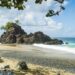 A general view of Turtle Beach, Tobago (also known as Courland Bay) showing sand, rocks, blue sea and sky