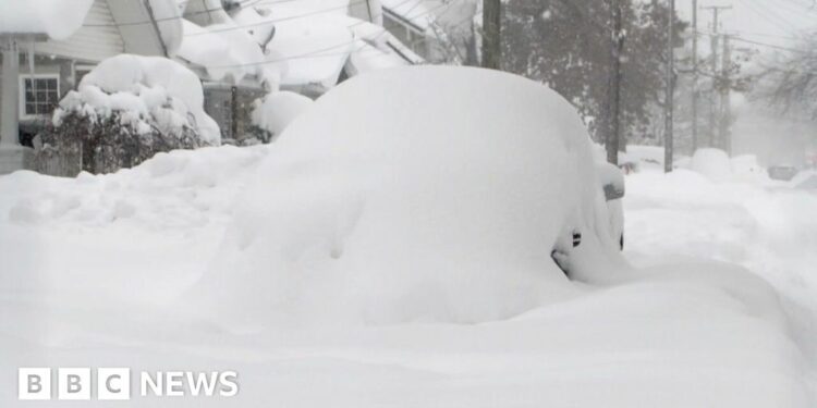 A car totally covered in snow