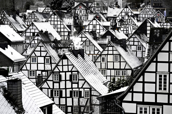 Snow falls on the roofs of the half-timbered houses in the historic city centre in Freudenberg, Germany.