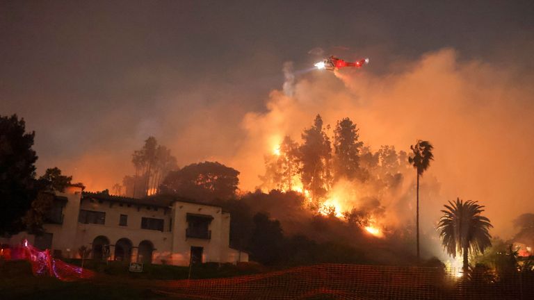 Flames rise from the Sunset fire in the hills overlooking the Hollywood neighborhood of Los Angeles, California, U.S. January 8, 2025. REUTERS/David Swanson