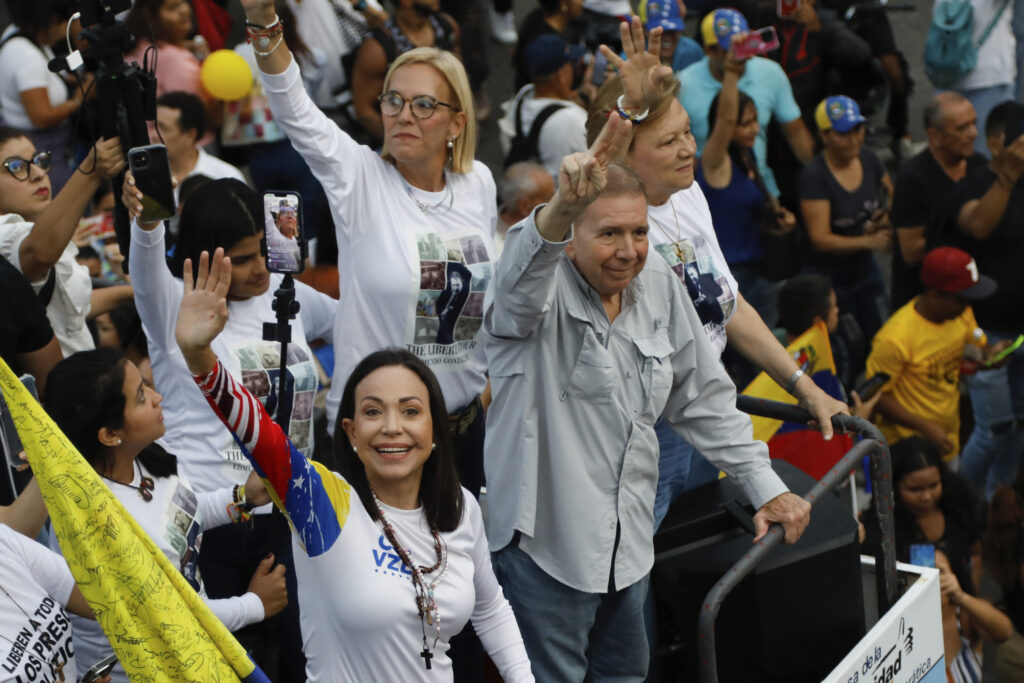 Opposition leader Maria Corina Machado, left, and the opposition's presidential candidate Edmundo Gonzalez wave during a closing election campaign rally in Caracas, Venezuela, Thursday, July 25, 2024. The presidential election is set for July 28.