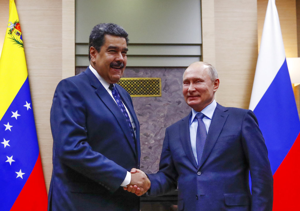 Russian President Vladimir Putin, right, shakes hands with his Venezuelan counterpart Nicolas Maduro during their meeting at the Novo-Ogaryovo residence outside in Moscow, Russia, Wednesday, Dec. 5, 2018.