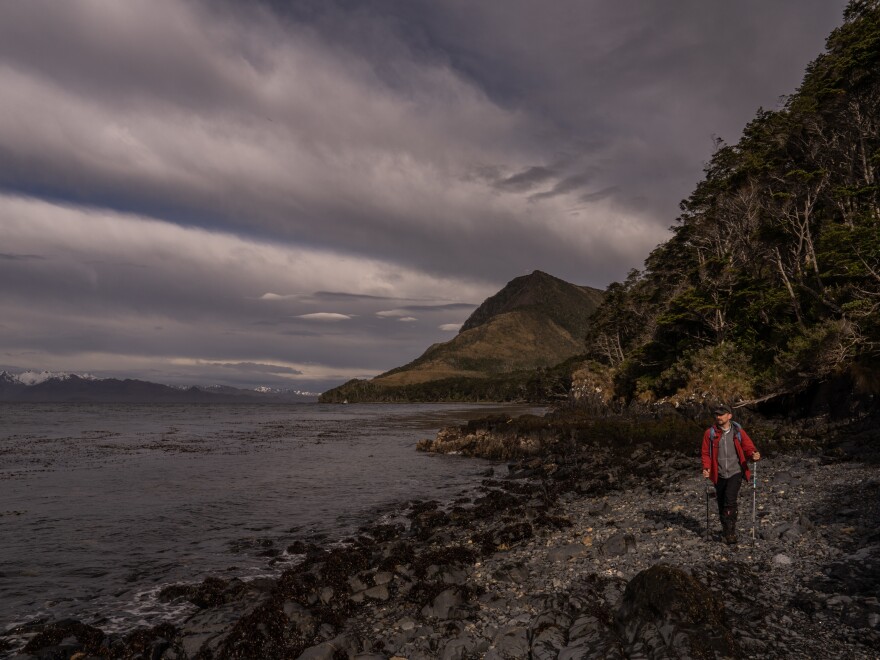 A member of the Cape Froward expedition group walks along the steep, rugged coastline, on Nov. 3, 2024.