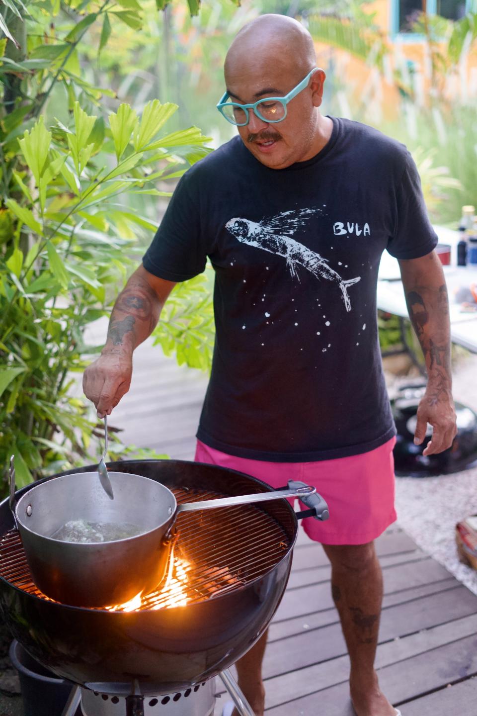 A local chef barbequing in the outdoors.