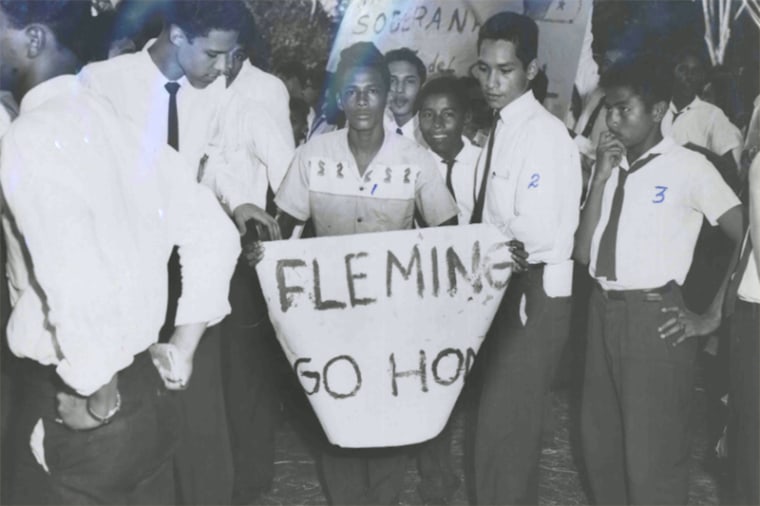 A student with a Banner saying Fleming Go Home, on Jan. 9, 1964.