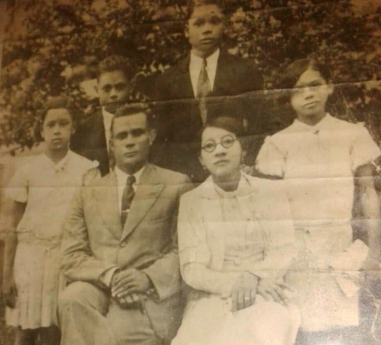 Panama Canal worker John Miller poses next to his wife and their four children. 