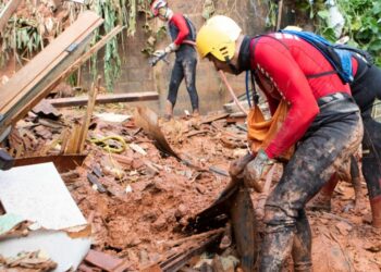 Firefighters work on a landslide site at Bethania neighbourhood, Ipatinga, Minas Gerais state, Brazil on January 12, 2025.
