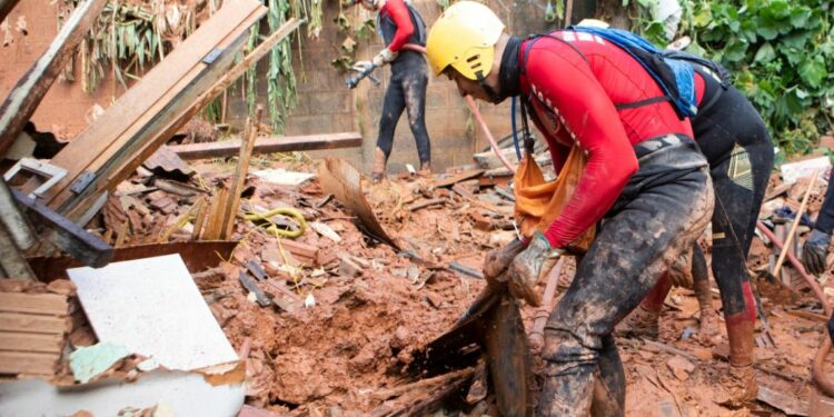 Firefighters work on a landslide site at Bethania neighbourhood, Ipatinga, Minas Gerais state, Brazil on January 12, 2025.