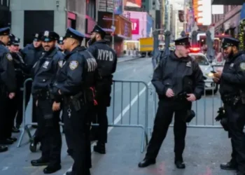 New York City Police Department (NYPD) officers stand watch in Times Square in New York City ahead of the New Year's Eve celebration on December 31