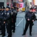 New York City Police Department (NYPD) officers stand watch in Times Square in New York City ahead of the New Year's Eve celebration on December 31